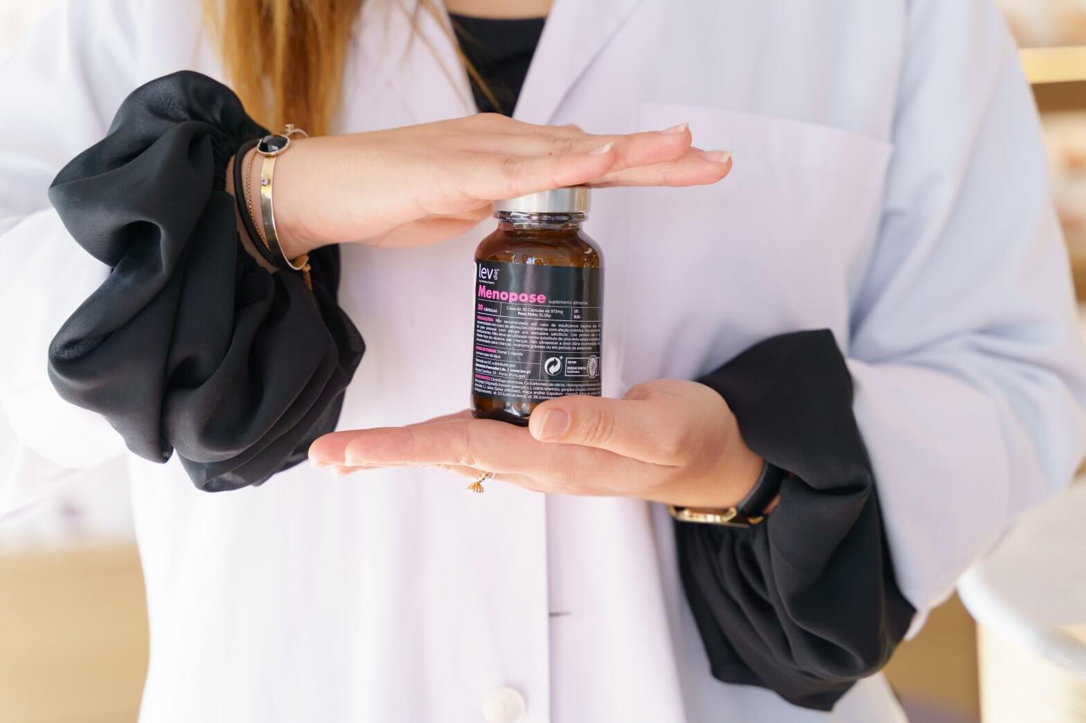menina com o suplemento menopose da lev para aliviar os sintomas da menopausa na mão